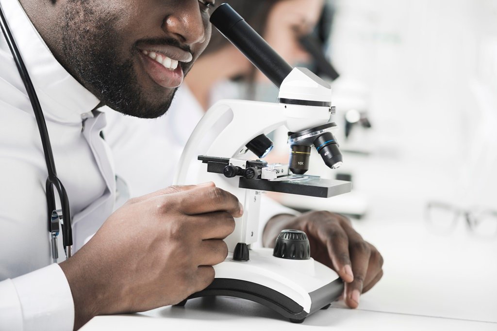 medic using microscope